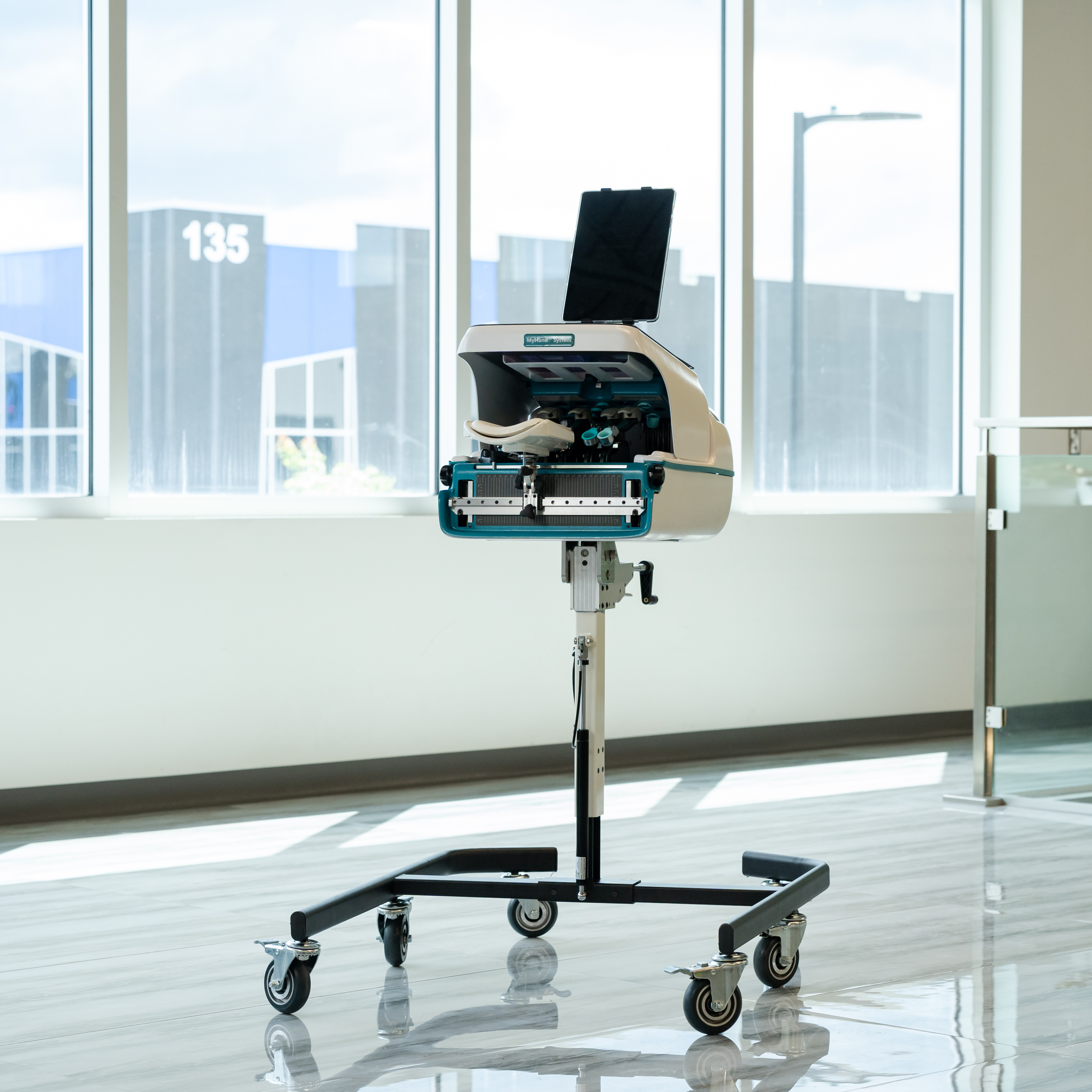 Patient playing interactive games on the MyHand System tablet